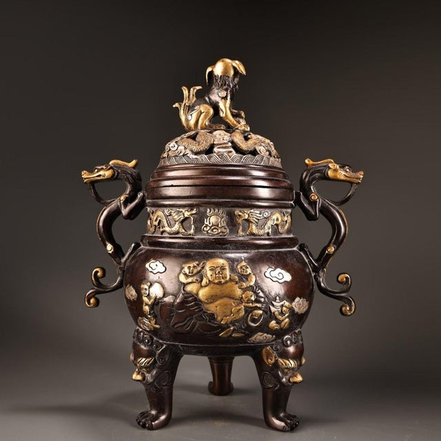 This is a striking and substantial decorative censer (incense burner), crafted from cast bronze with rich gilded (gold-...
