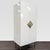 The wardrobe stands on steel legs with a wood frame that supports one fixed shelf with a removable brass pole for hanging...