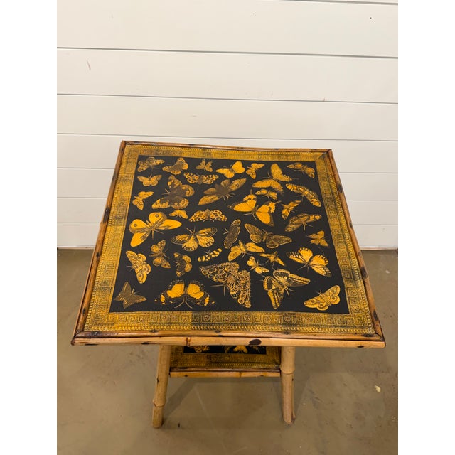 This 19th Century English Bamboo Side table features a delightful variety of butterfly decoupaged onto the top and lower...
