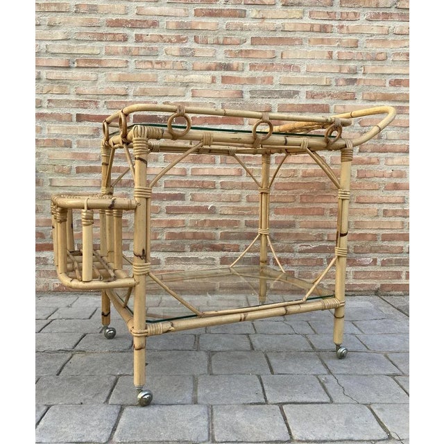 Mid-Century Modern bamboo tea cart. Fabulous from the 1950s. Made in bamboo with two large wheels. Bottle rack on the...