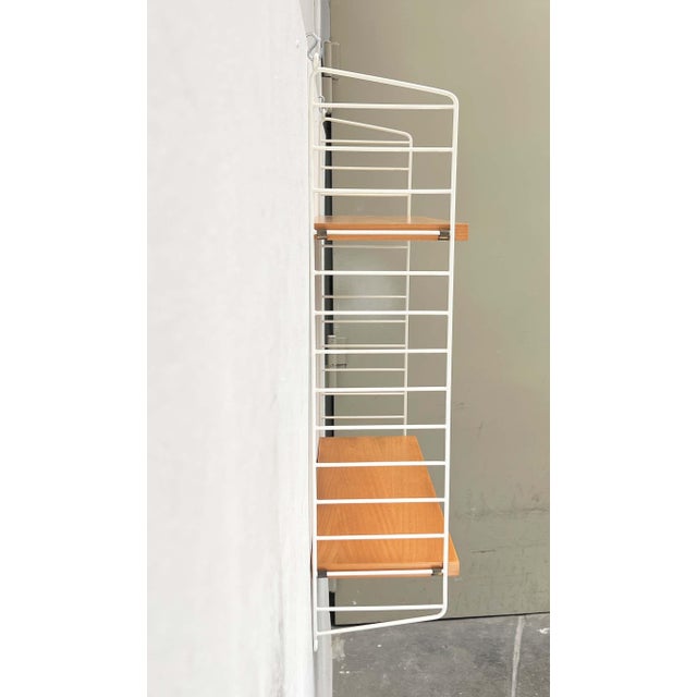 Original String shelving unit with white ladders and two shelves. Classic String shelving unit with white ladders. The...