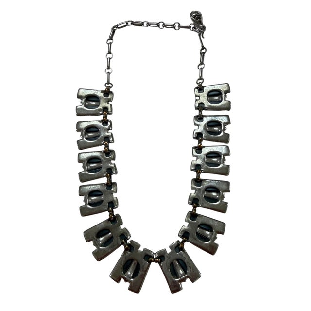 A rare find in the way of color! Vintage Mid-century modernist necklace by Coro in Dark Gray Lucite. The distinctive...
