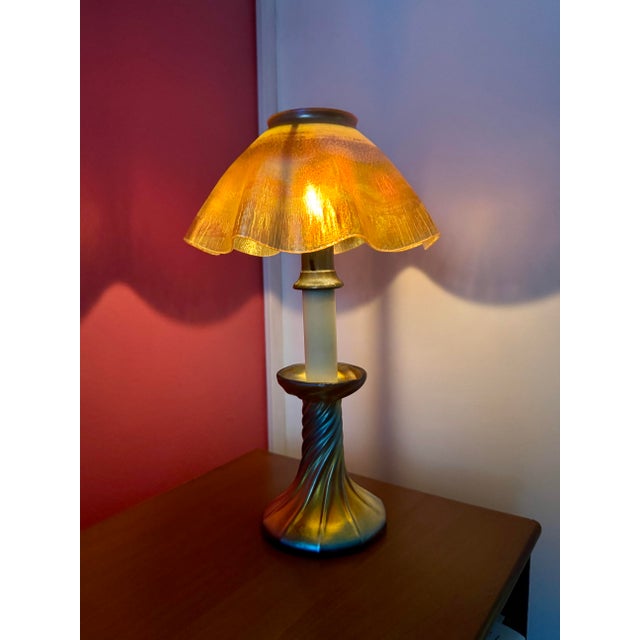 This beautiful original Favrile glass candle lamp was made by (as is signed by) Louis Confort Tiffany around the turn of...