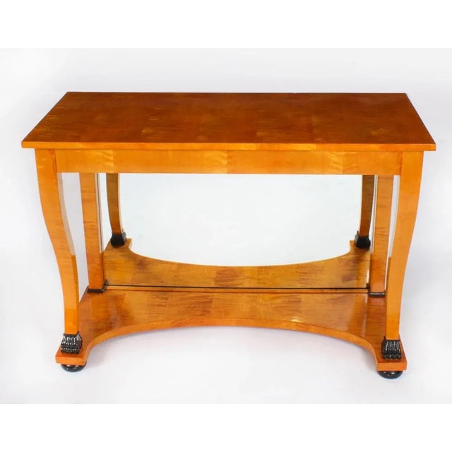 This is a stylish antique Swedish Biedermeier Period birch with ebonised detail console table, circa 1830 in date. The...