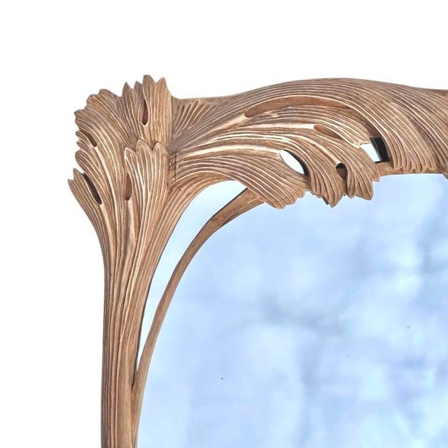 An exquisitely carved, solid wood mirror with sweeping ginkgo leaf motifs. The wood showcases a fine, linear grain and a...