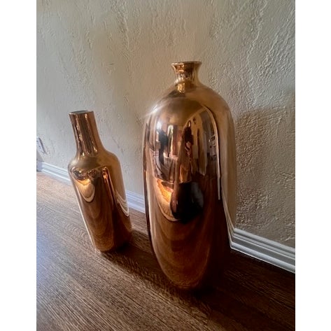 A pair of large decorative vases. Liquid gold finish. Very distinctive and lovely Vases in good condition. Some...
