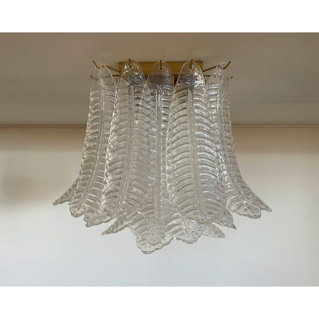 Spectacular ceiling lamp with 32 Muranotransaparent leaves in golden painted metal frame. Elegant lighting object. Period:...