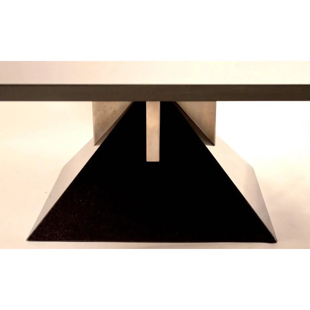 Classic 1980s Art Deco Revival square coffee table on polished granite pyramid base with brushed steel supports. Top...