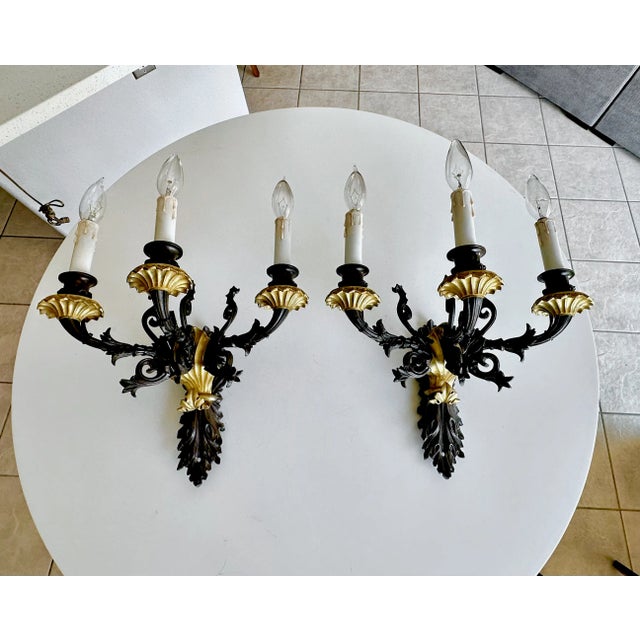 Pair of patinated bronze Empire-style wall sconces made in France in the late 19th Century. These are made of quality...