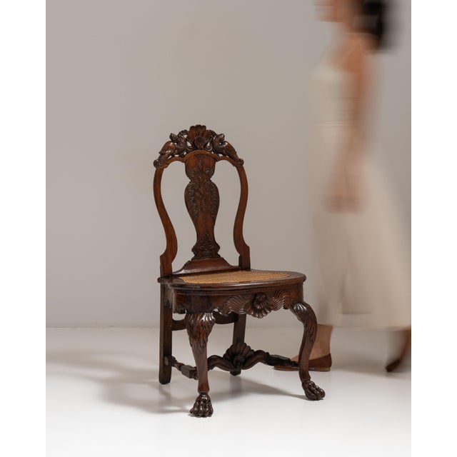 This 19th century Ceylon George I colonial chair with rattan seat from United Kingdom is made in dark wood with an...