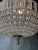 A beautifully detailed crystal spherical chandelier in a classic globe shape, full of sparkle and texture. The frame is...