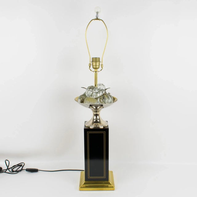 Stunning decorative tall table lamp by Maison Charles, Paris. The brass lamp is raised on a large square black enameled...