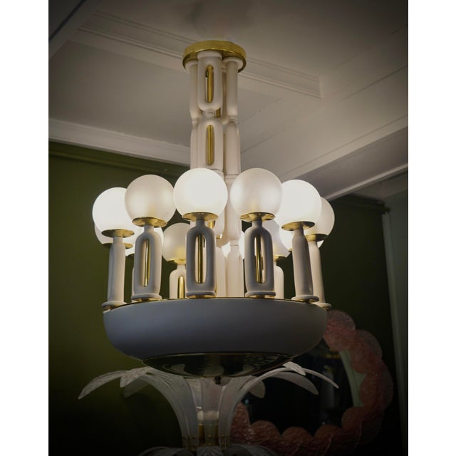 Linear but refined, this brass and white ceramic chandelier shows all the meticulous and complex manufacturing with which...