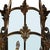 A lantern chandelier crafted in brass, featuring nine candle style lights enclosed within tall, gracefully curved glass...