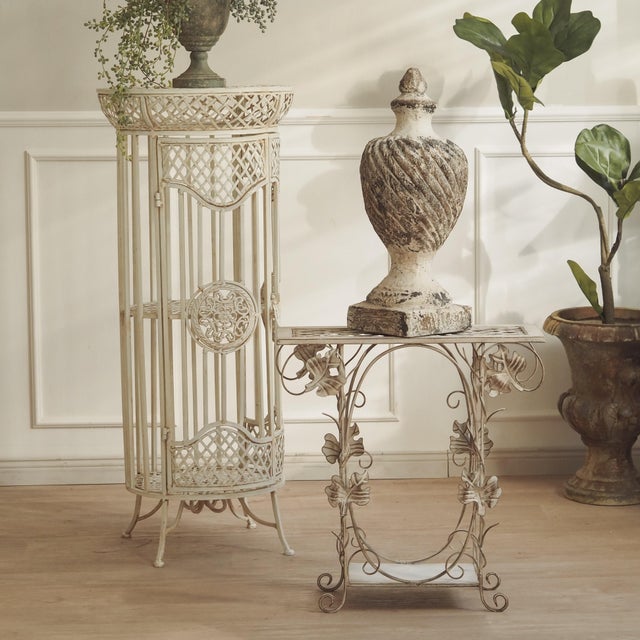 A contemporary metal furniture piece featuring a deliberately understated, historically inspired finish. Its slender...