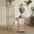 A contemporary metal furniture piece featuring a deliberately understated, historically inspired finish. Its slender...