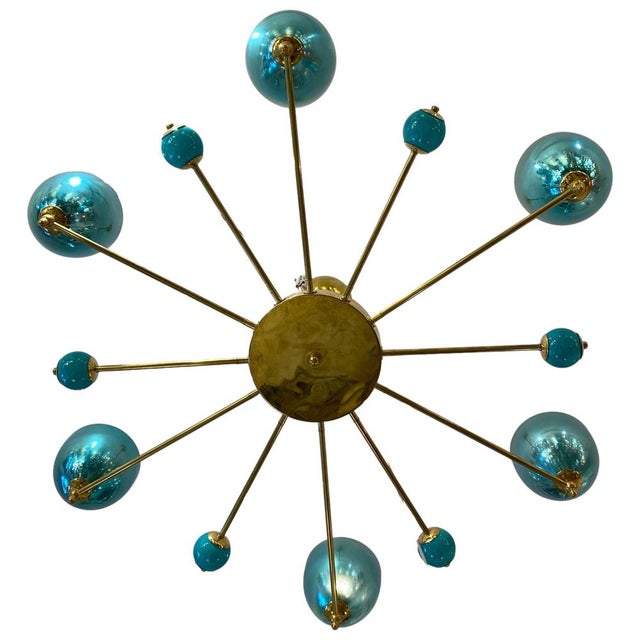 Italian ceiling lamp made of Murano glass, 1980s. It features a central body of gilded brass with 12 arms. Six of these...