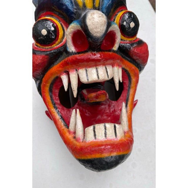 This vintage colorful mask is a unique and culturally significant piece of art that showcases the rich traditions of...