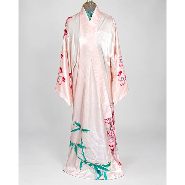 Beautiful vintage silk kimono-style robe featuring a dramatic peacock design with pink cherry blossoms, teal accents, and...