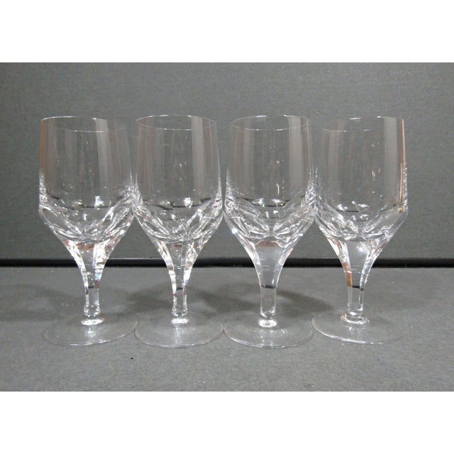 An elegant set of four vintage Josair “Napoleon” cut crystal wine glasses, distinguished by their sculptural cut-panel...