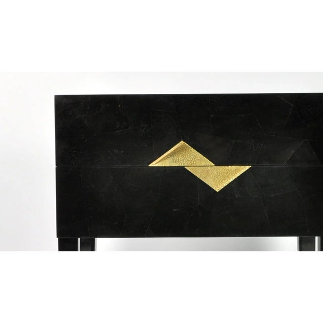 Bedside tables made of black marquetry with casted brass handles. The tables have 2 drawers. Stamped by Maker