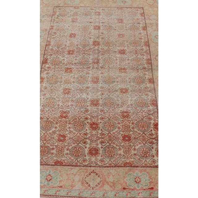 Antique Persian Tabriz rug with all-over floral design in light blue/ light green, salmon, coral, red-coral, and cream rug...