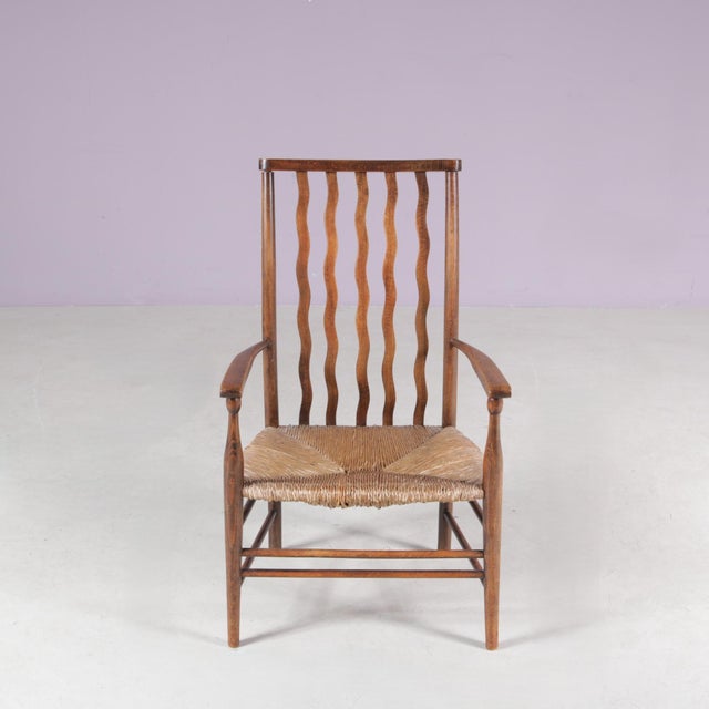 This charming 1930s low spindle-back hearth chair, attributed to the Arts & Crafts tradition and retailed by Liberty &...