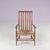This charming 1930s low spindle-back hearth chair, attributed to the Arts & Crafts tradition and retailed by Liberty &...