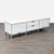 This Scandinavian Designs cabinet features a modern white finish with light wood accents and metal legs. It offers two...