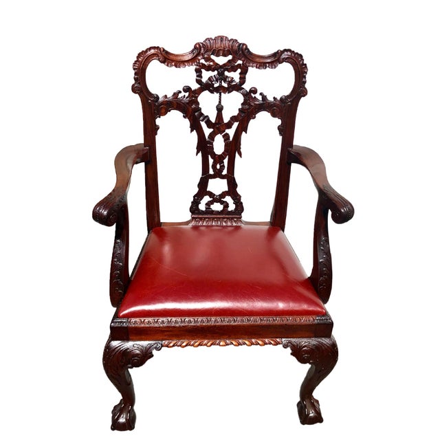 This distinguished set of eight English carved mahogany dining chairs, circa 1870, reflects the refined craftsmanship of...