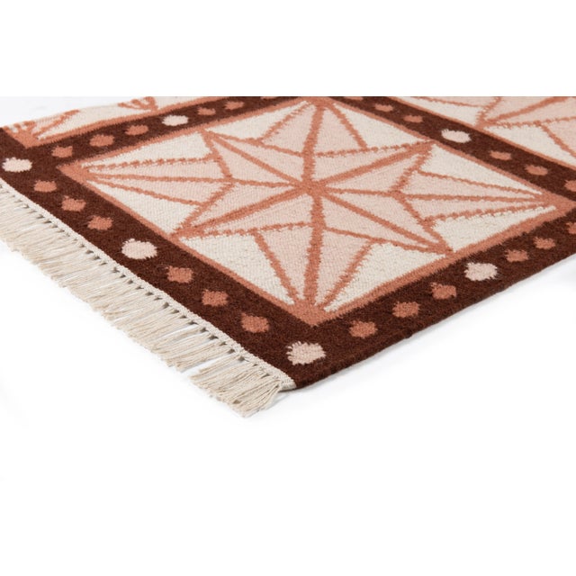 The serene beauty of the Star Rug was inspired by Moroccan tiles and antique American quilts. Symmetrical starbursts...