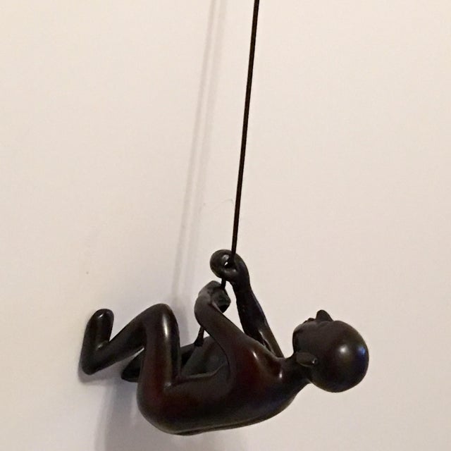 Black climbing man wall art. New design, bigger and heavier climbing figure. This is position 2. Great gift for the holidays!