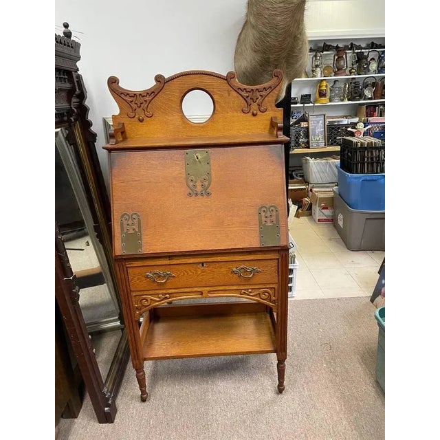 Antique Flip down Tiger oak cabinet. It has a overhead shelf with a large center hole. Not sure if this was a mirror at...