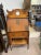 Antique Flip down Tiger oak cabinet. It has a overhead shelf with a large center hole. Not sure if this was a mirror at...