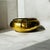 The item made of solid brass with a hammered finish, giving it a textured, reflective appearance. It has a decorative...