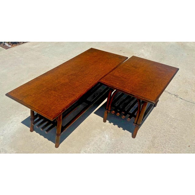 This is a set of two vintage bamboo and walnut-colored wood tables. They have rectangular tops with molded edges sitting...