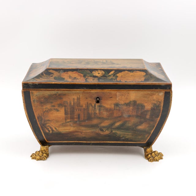 A painted and penwork bombe-form box, the body swelling outward on all four sides and tapering to a raised rectangular lid...