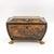 A painted and penwork bombe-form box, the body swelling outward on all four sides and tapering to a raised rectangular lid...