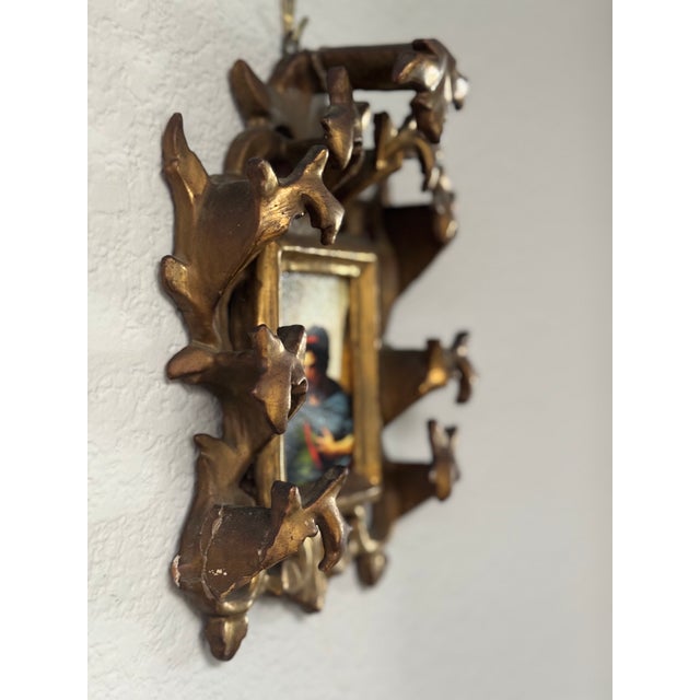 A beautifully detailed vintage hand-carved wood and gilt picture frame, featuring an elaborate openwork design of...