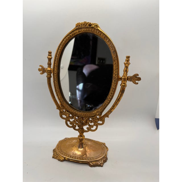 Gorgeous French solid brass dressing tabletop swivel mirror with ornate knobs to adjust the angle. No maker's mark. This...