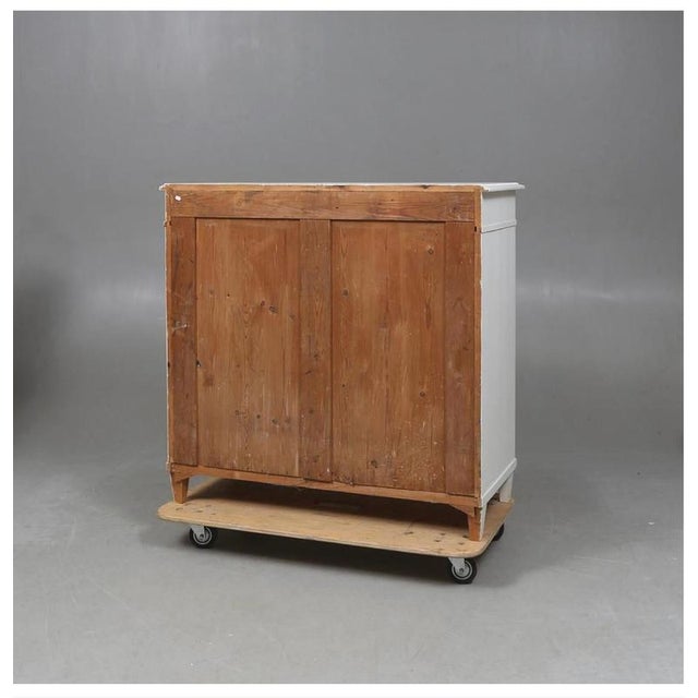 Buffet commode in gustavian style with classic Gustavian diamond ribbing detail on the drawer fronts and leading edges. It...