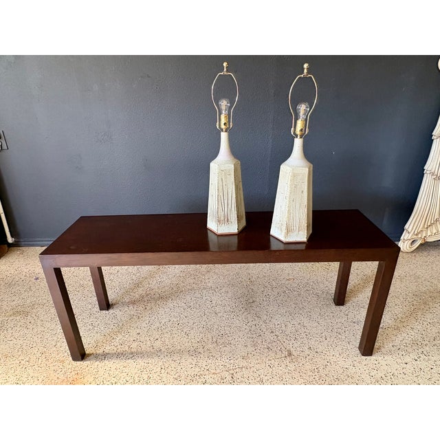 1970's Peter Swanson style pair of Table lamps, features a wheat straw glaze with incised birds and wheat motifs. Its hand...