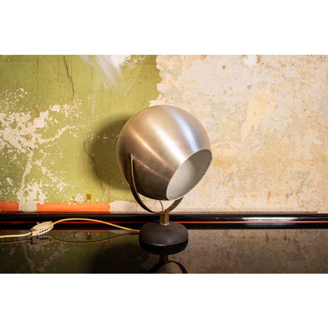 Table lamp with aluminum frame and cast iron base. Adjustable. Made in Italy in the 1960s. European Plug (up to 250V).The...