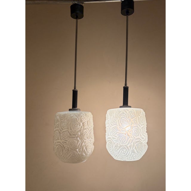 Geometric textured glass pendants to warm up your home. The embossed design is exceptional— it gives a sculptural quality...
