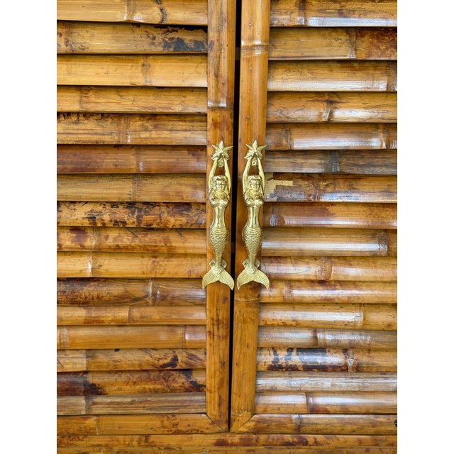 A truly exceptional and highly unique vintage bamboo wall cabinet, designed to make a statement while offering functional...