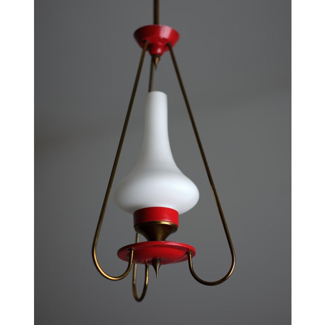Italian pendant chandelier with three arms, made with red enameled metal , brass and opaline glass . Elegant and modern...