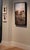 This oil on canvas artwork depicts a striking urban scene featuring the iconic "New Yorker" sign atop a series of...