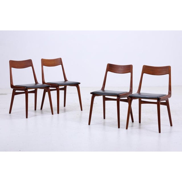 Beautiful set of four Model 370 "Boomerang" chairs from the 1960s, featuring a distinctive, gently curved back and clean...