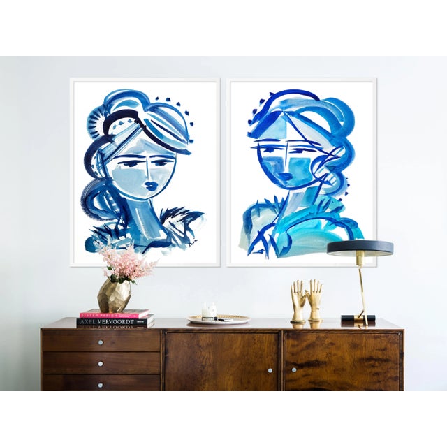 DESCRIPTION: Blue Girls Diptych by Maren Devine in White Frame, Medium Art Print SPECIFICATIONS: Type: Framed Paper....