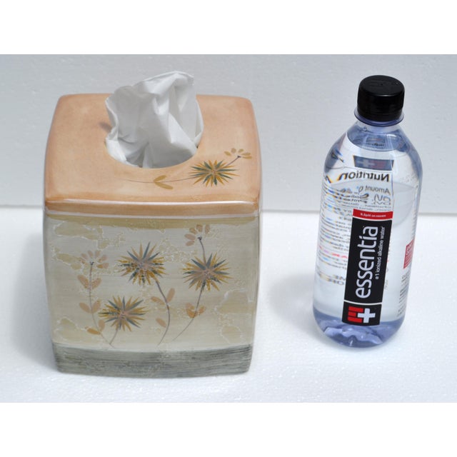 Luxury square ceramic tissue box cover with a soft beige and tan color scheme. The top surface is a warm peach-beige tone...